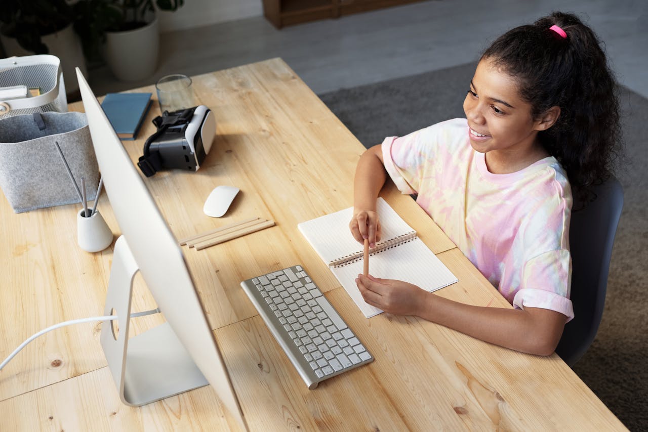 Girl in Pink T-shirt Looking at the Imac